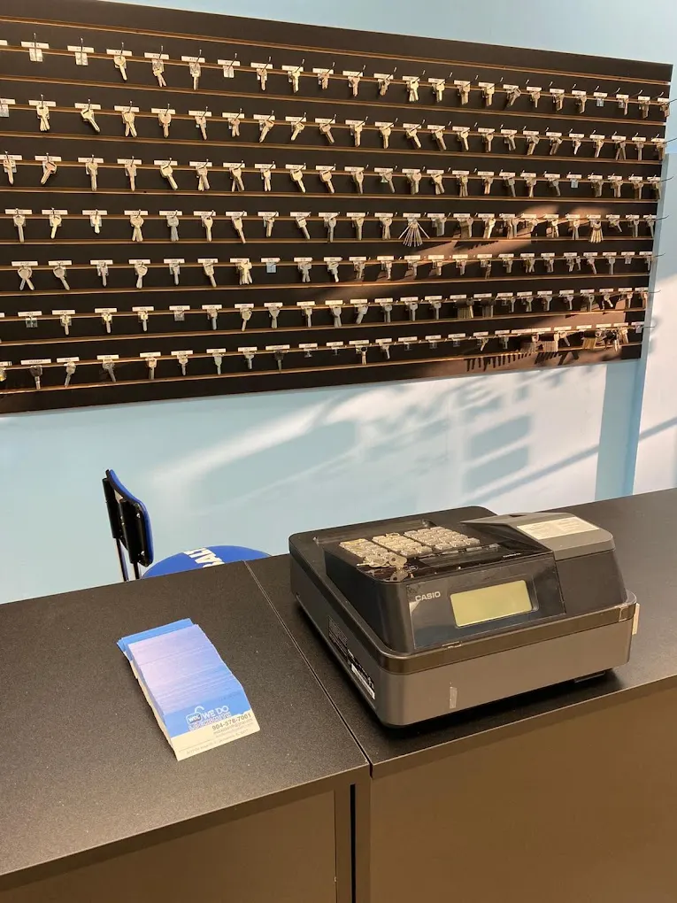 Wall of key blanks and a key cutting machine in the We Do Locksmith shop