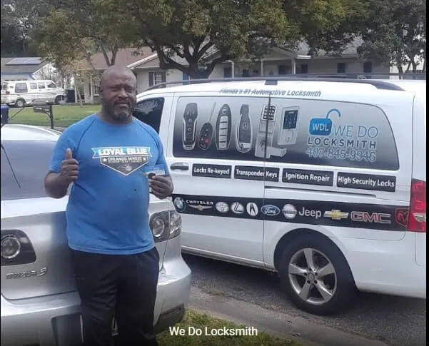 We Do Locksmith technician giving a thumbs up beside a wrapped service van