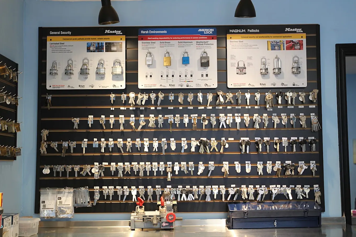 Wall of padlocks, deadbolts and key blanks in the We Do Locksmith shop
