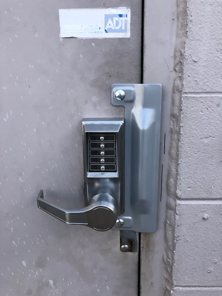 Push-button keypad lock installed on a steel door